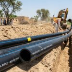 MDPE pipe Pakistan installation for underground water distribution being laid in a trench by workers at an infrastructure project.