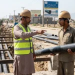 Workers installing pipes at a construction site as Pakistan's pipe industry grows