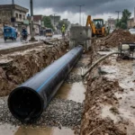 Monsoon drainage pipe Pakistan installation in a wet underground drainage trench